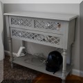 F28. Mirrored and lattice console table. 30.5"h x 32"w x 13"d 